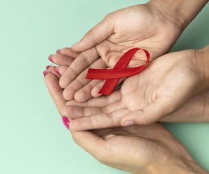 people-holding-world-aids-day-red-symbol
